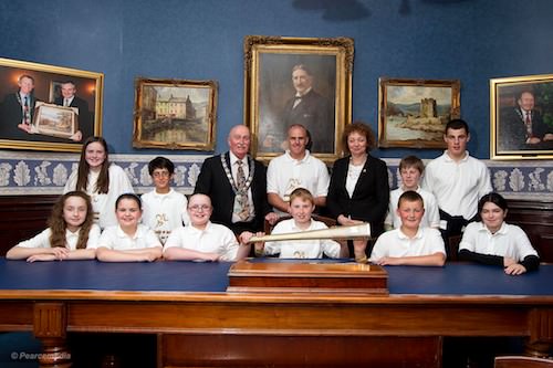 Prize-winners from primary schools in Newry, Bessbrook, Crossmaglen, Belleek, Cabra and Rostrevor pictured with the Minister for Sport, Carál Ní Chuilín, the Mayor of Newry Councillor Charlie Casey and Banjo Bannon. Picture: Mark Pearce